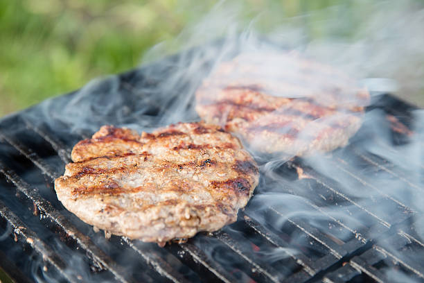 istock fresh beef burgers on smoky grill 541270300