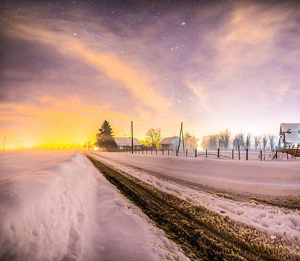 Snowy path under the stars and sky on cold winter night
