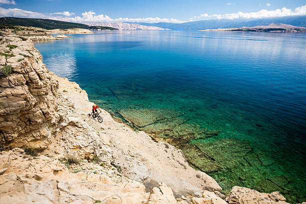 istock Mountain biker riding on bike in summer seaside 541271122