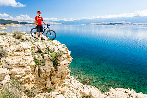 istock Mountain biker looking at view and riding on bike 541271182