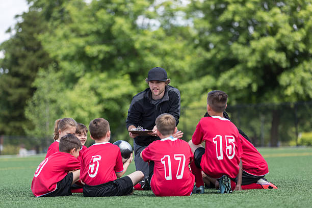 istock Kids soccer team listenting intently to their coach 541271186