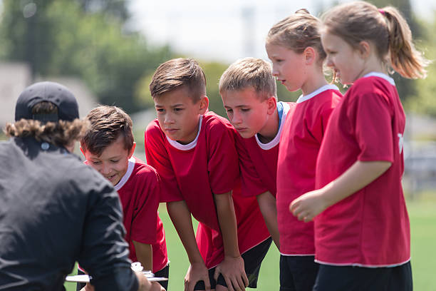 istock Kids soccer team listenting intently to their coach 541271222