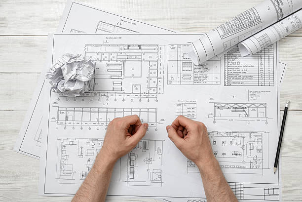 istock Close-up hands of architect working with a drawing 541271402