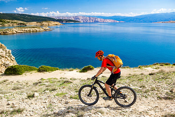 istock Mountain biker riding on bike in summer seaside 541271432