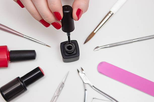 istock desktop manicurist. Manicure. Girl with red nails 541275850