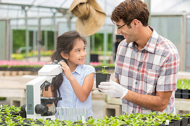 istock Smiling teacher and student learning about plants 541276658