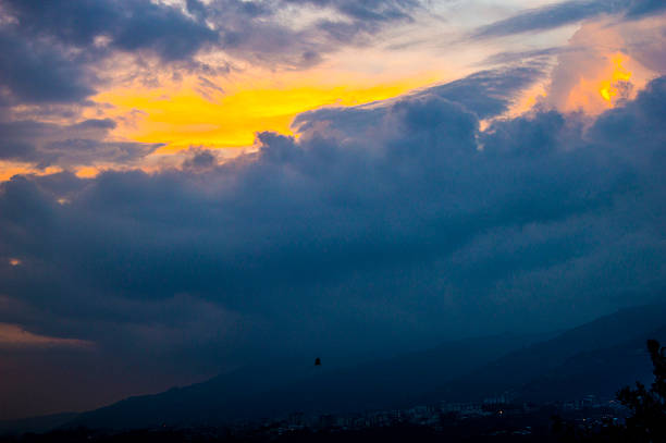 街のロスアンデスの上の雲の中の黄金の太陽. - sunspot ストックフォトと画像