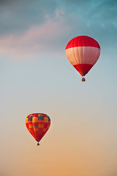 istock Red hot air balloons in blue sky with white clouds 541277794