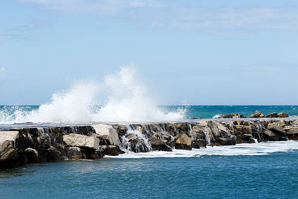 Waves breaking on the breakwater stock photo