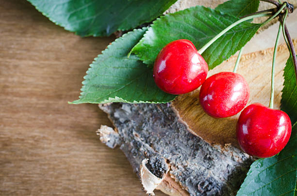 istock Fresh ripe organic cherries on wooden background. Rustic style. 541283494