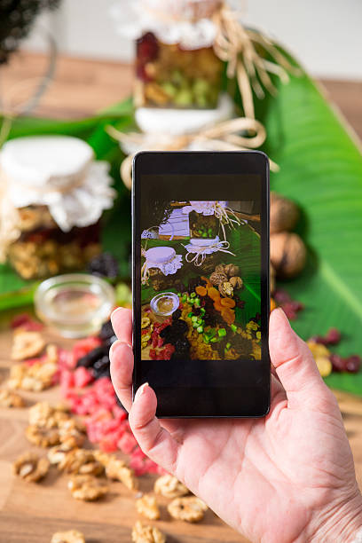istock Photographing with cell phone arrangement on dried fruit mix. 541283550
