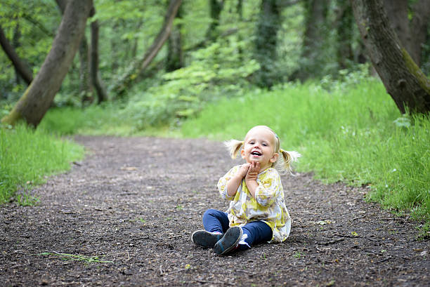 Happy little girl in the wood stock photo