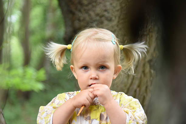 Portrait of cute little girl in the park stock photo