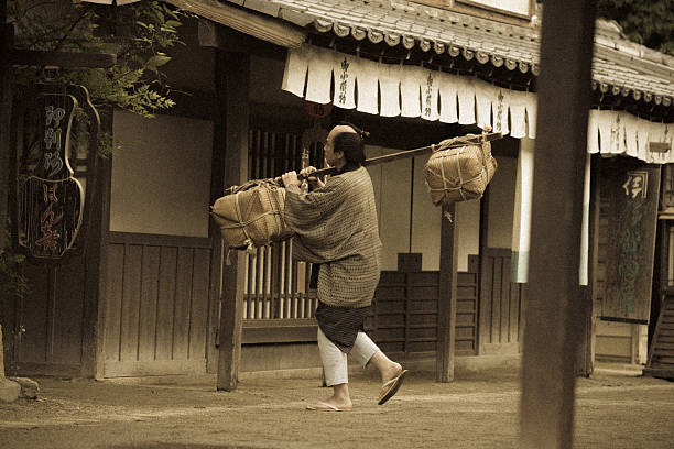 istock Historical Japanese village and farmer with parcels 541285138