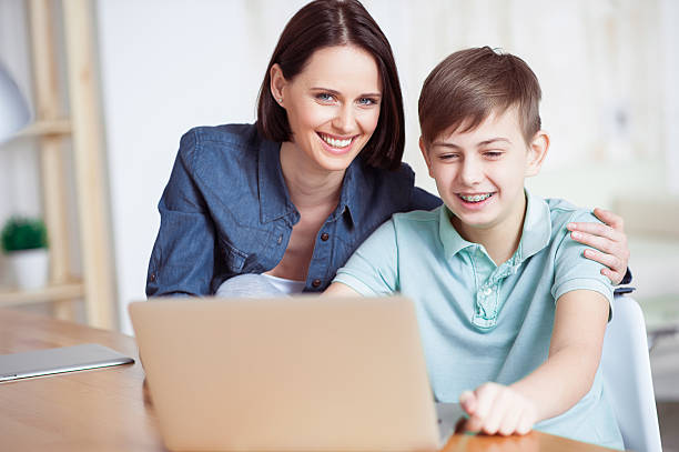 istock Happy mother helping his son to do homework 541287954