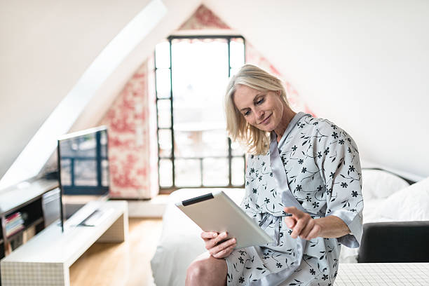 istock woman using the tablet after the wake up at home 541288522