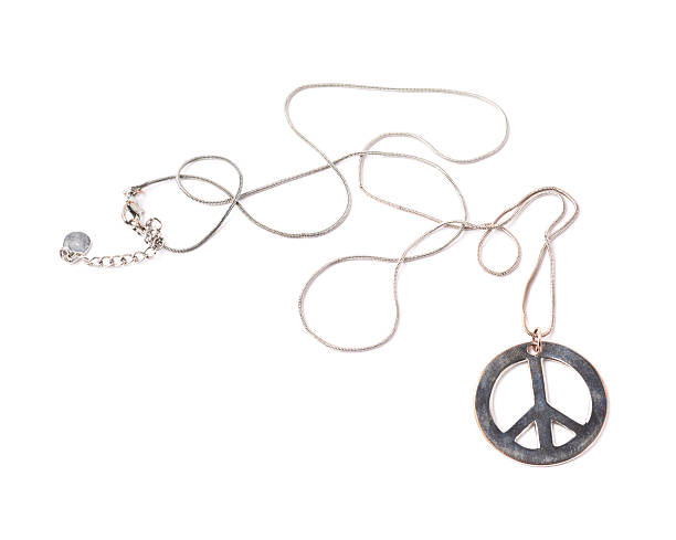istock Worn metal peace sign necklace isolated 541288936