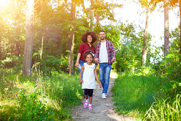 istock Happy family walking along a path in the woods 541291438