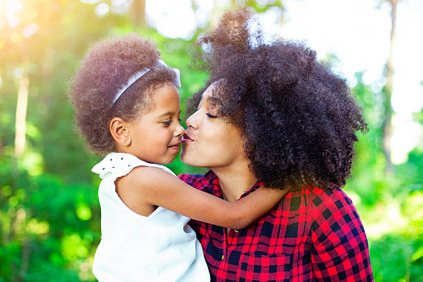 istock Mother and daughter hugging outdoors 541291762