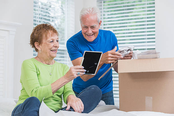 istock Senior couple packing box, looking at picture frame 541294042