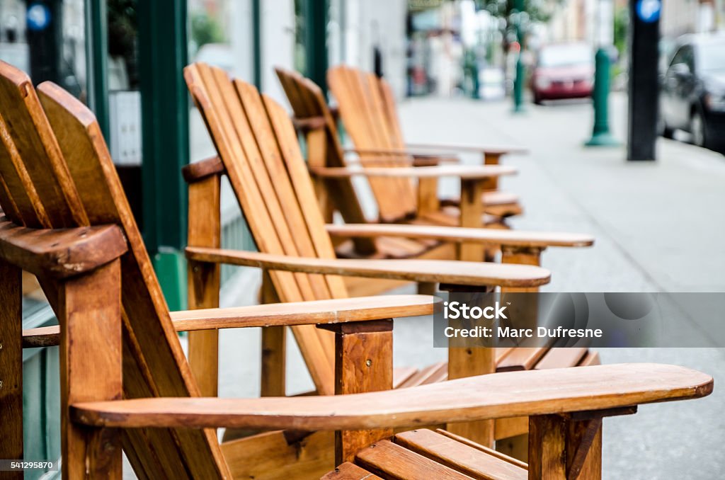 Row of wooden chairs on sidewalk Row of wooden chairs on sidewalk with short depth of field Sherbrooke - Quebec Stock Photo