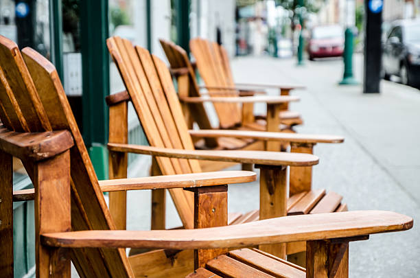 Row of wooden chairs on sidewalk Row of wooden chairs on sidewalk with short depth of field sherbrooke quebec stock pictures, royalty-free photos & images
