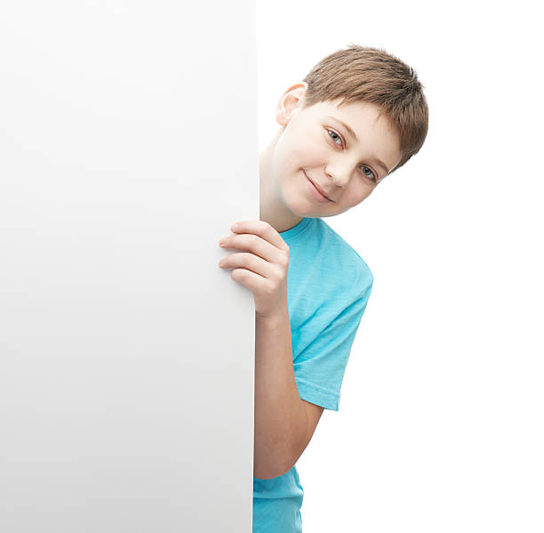 istock Smiling oung boy with a sheet of paper 541302214