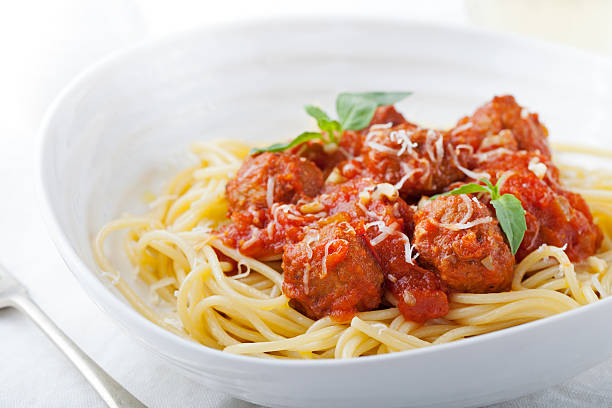 istock Meatballs in tomato sauce and fresh basil with spaghetti 541303138