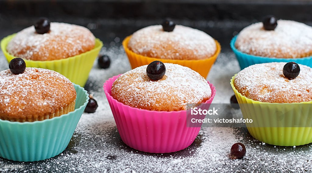 Muffins with black currant in silicone forms sprinkled Muffins with black currant in silicone forms sprinkled with powdered sugar Silicone Stock Photo