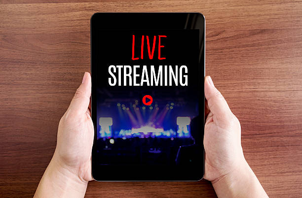 istock Two hand holding tablet with Live streaming and play icon 541304024