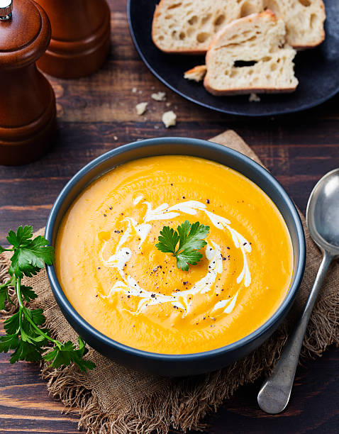 istock Pumpkin and carrot soup with cream and parsley 541305522