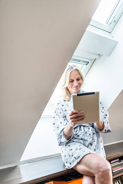 istock woman using the tablet after the wake up at home 541306890