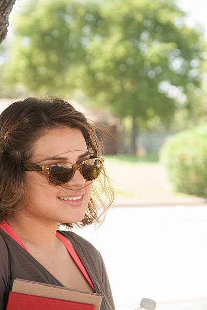 istock High school or college girl, student on campus. 541307176