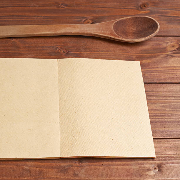 istock Wooden spoon next to recipe book 541308484