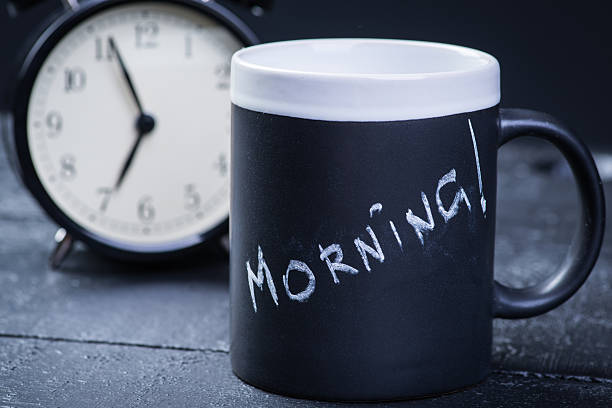 istock Black tea cup with alarm clock on wooden table 541311054