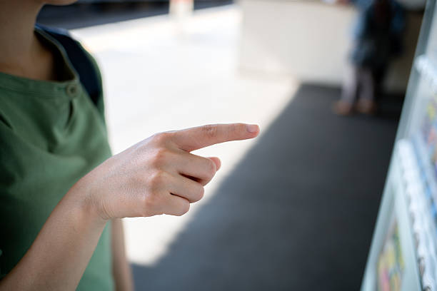 istock Asian woman pointing vending machine 541566394