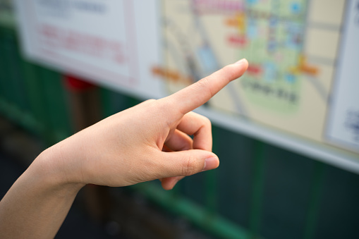 Asian woman pointing map.