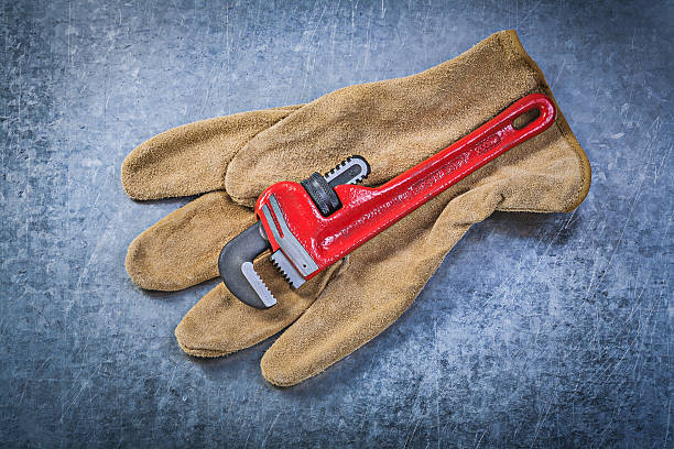 istock Monkey wrench leather protective gloves on scratched metallic ba 541567508