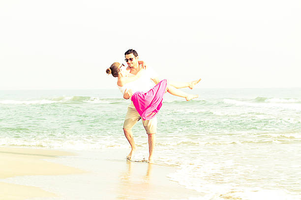 istock Happy Couple Having Fun At The Beach 541567854
