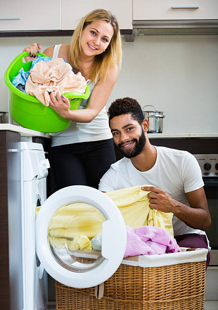 istock man and girl near washing machine 541571796