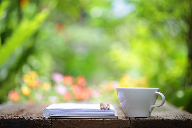 istock Notebook with pencil and cup on wooden table 541576450