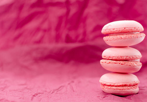 istock Three pink macaroon one on top of another 541576910