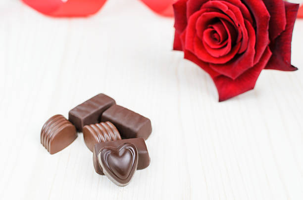 istock Chocolate candies and red rose 541578224