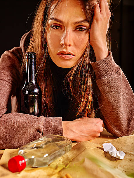 istock Girl in depression drinking alcohol. 541580038