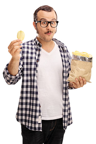 istock Joyful young man eating potato chips 541581790