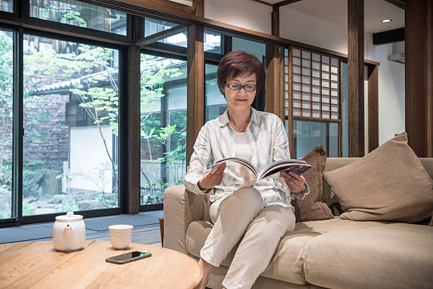Japanese woman on sofa reading magazine