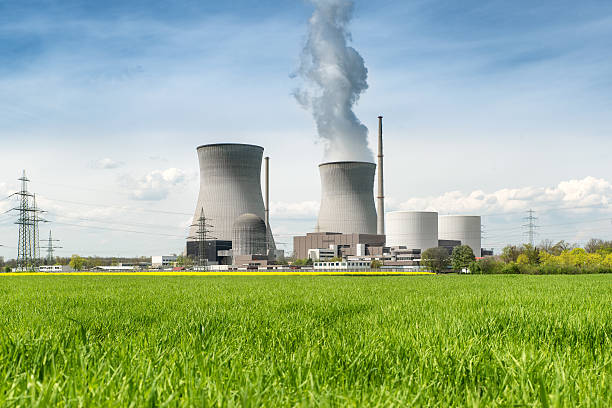 istock Nuclear power plant with green field and big blue clouds. 541582388