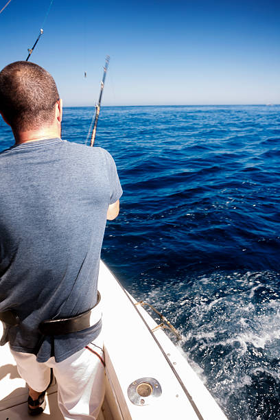 istock Man Catching Big Fish in Ocean 541584740