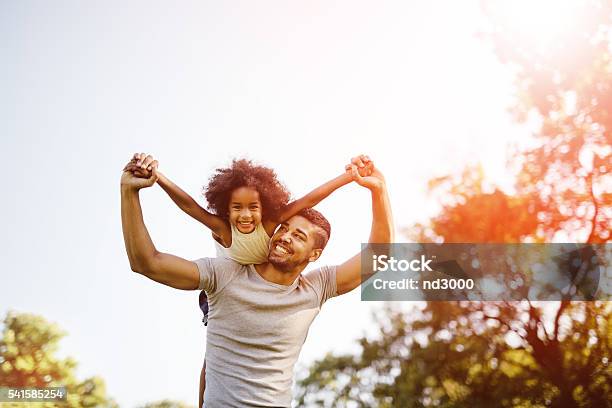 Father Carrying Daughter Piggyback Stock Photo - Download Image Now - Family, Father, Multiracial Group