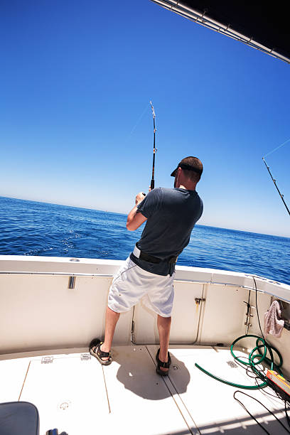istock Man Catching Big Fish in Ocean 541585810